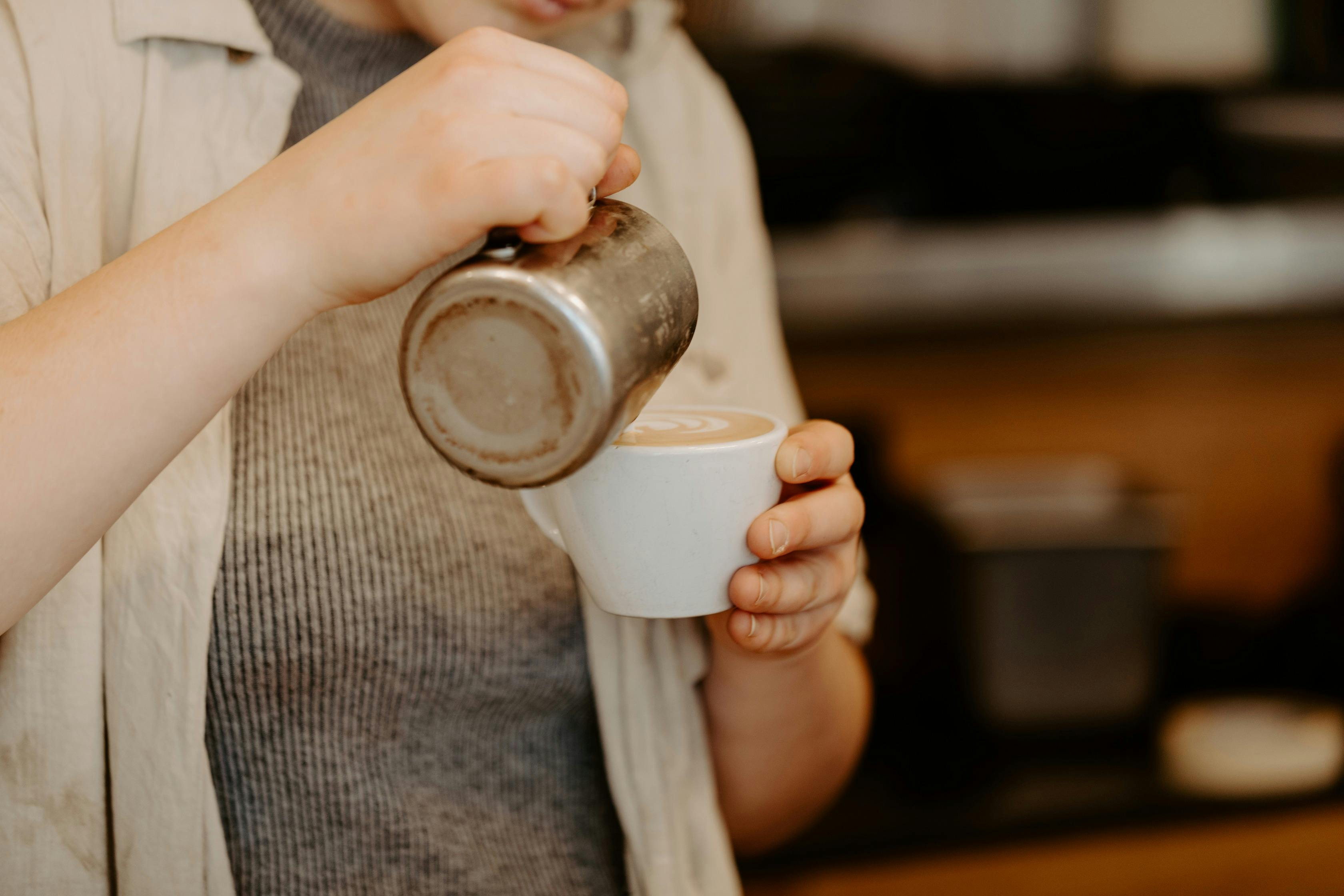 barista pouring coffee