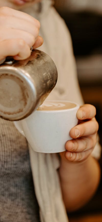 barista pouring coffee