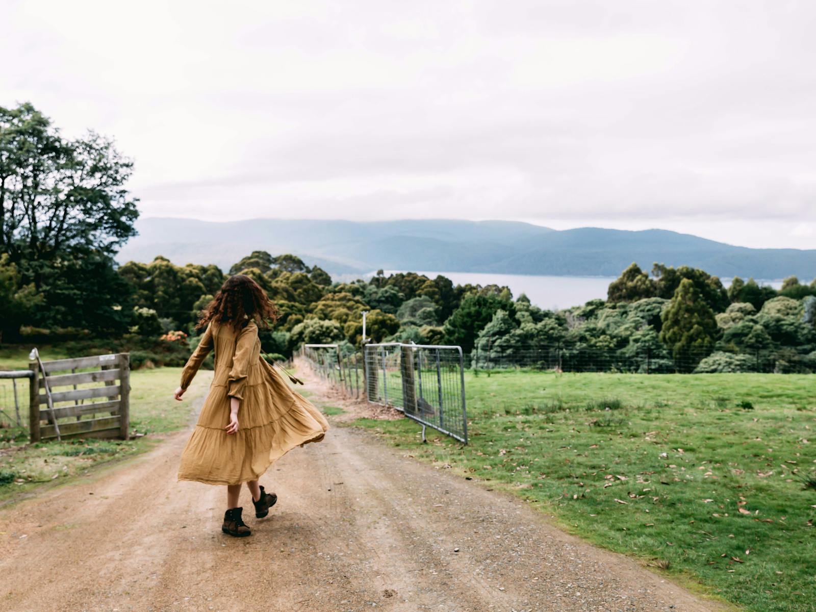 Girl on country driveway looking at spectacular view over three capes track