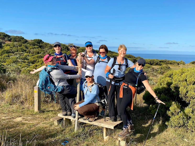 Women Embrace Adventure crossing a Style together on a hike