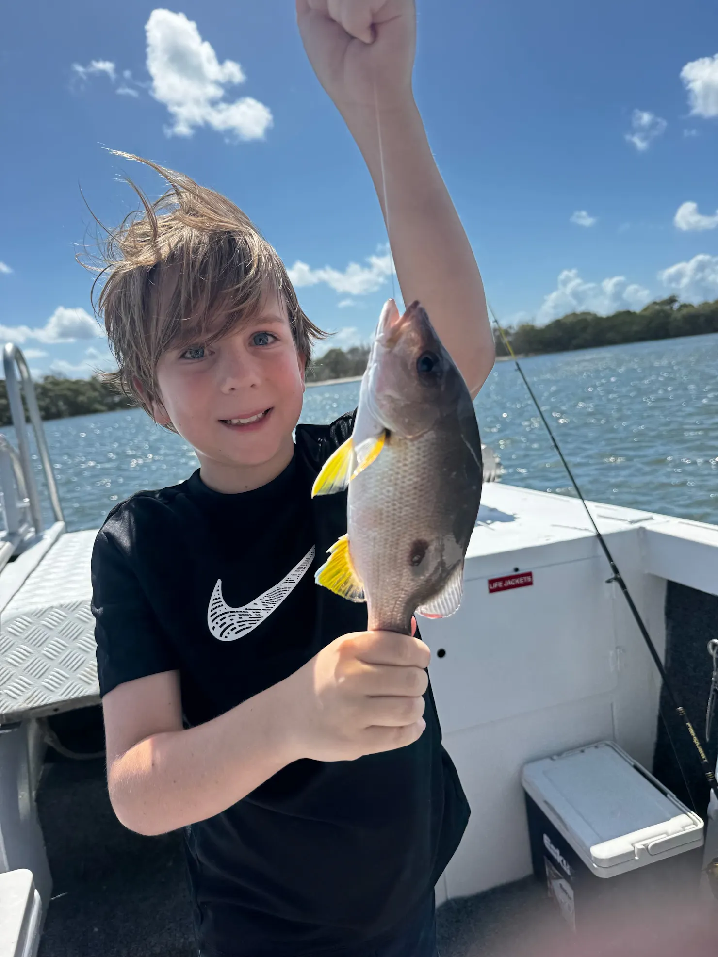 child fishing onboard caloundra charter company