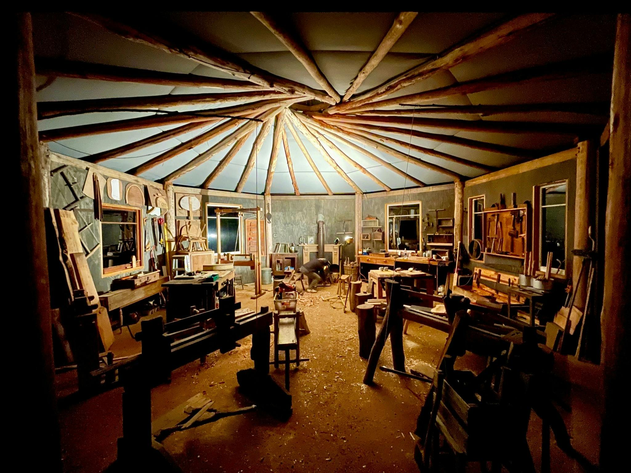 Night time inside the Wisdom Through Wood workshop. Reciprocated roof.