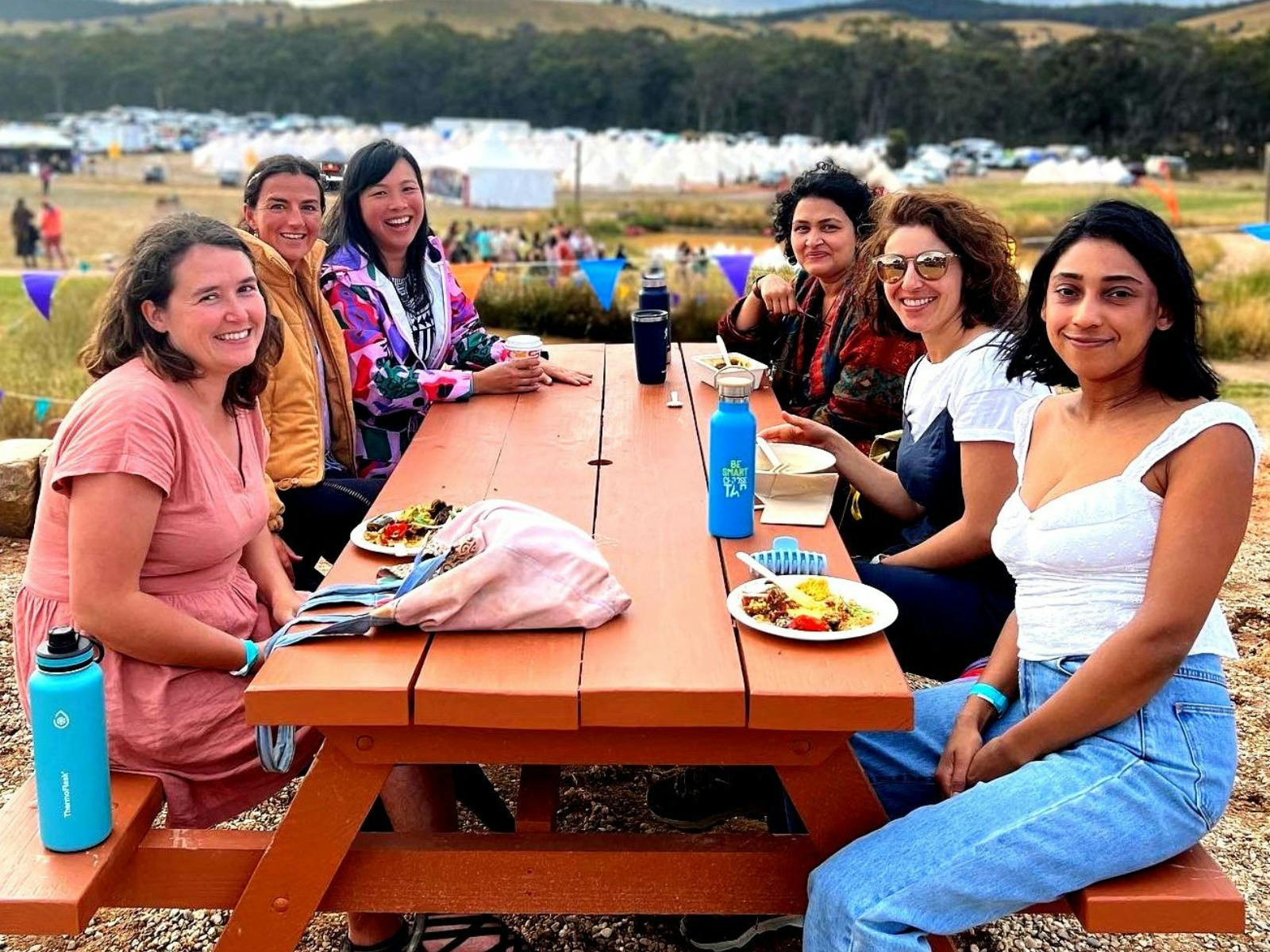 Women eating lunch at picnic table