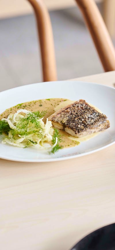 A fish dish and a glass of wine