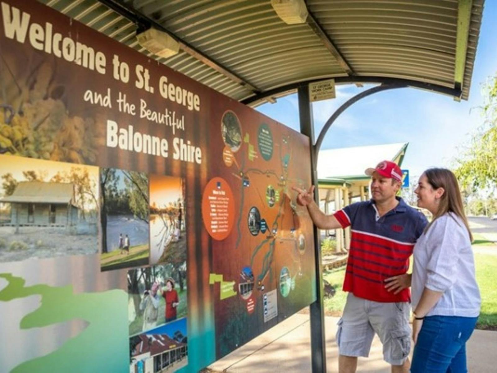 Man and Woman looking at Welcome to St George and Balonne Shire sign Man and Woman looking at Welcome to St George and Balonne Shire sign