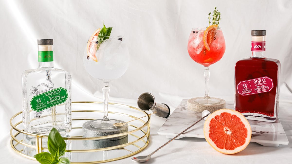 Gin bottles and cocktails with citrus garnish at Mt Uncle Distillery