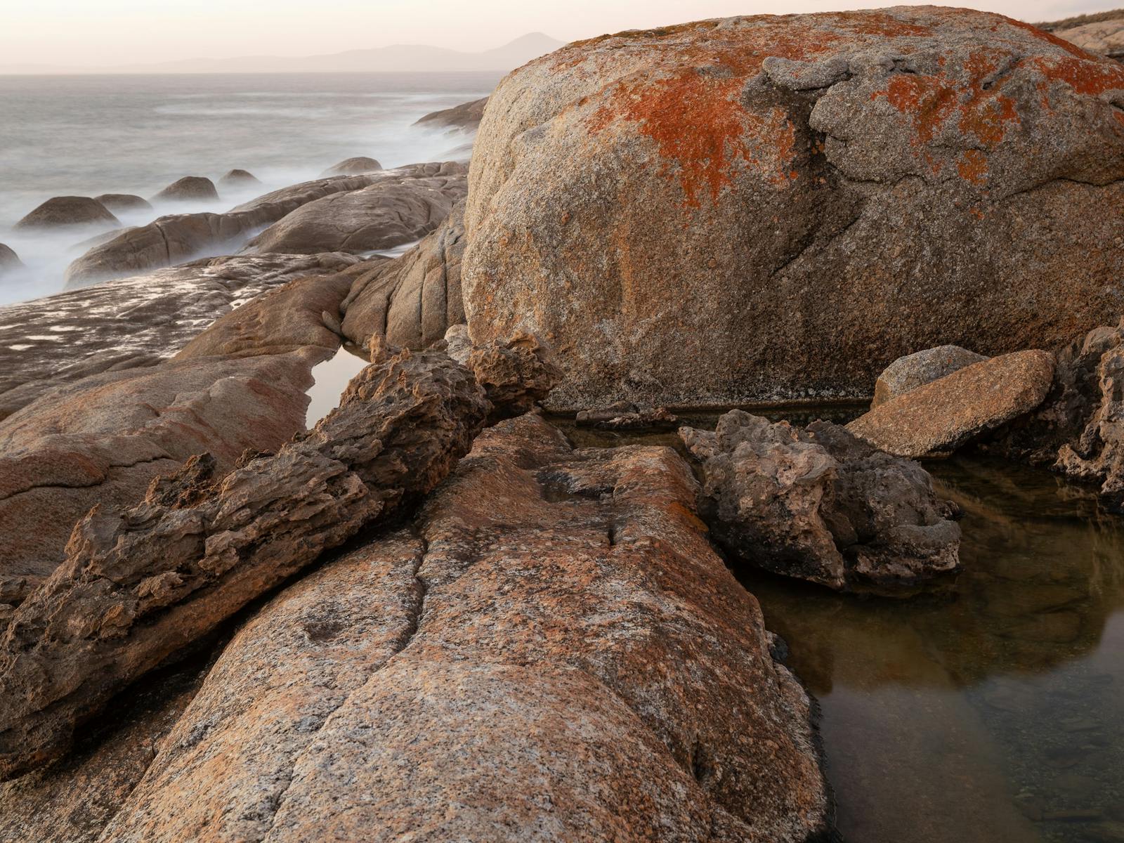 Coastal boulders decorated with vibrant lichen on Flinders Island