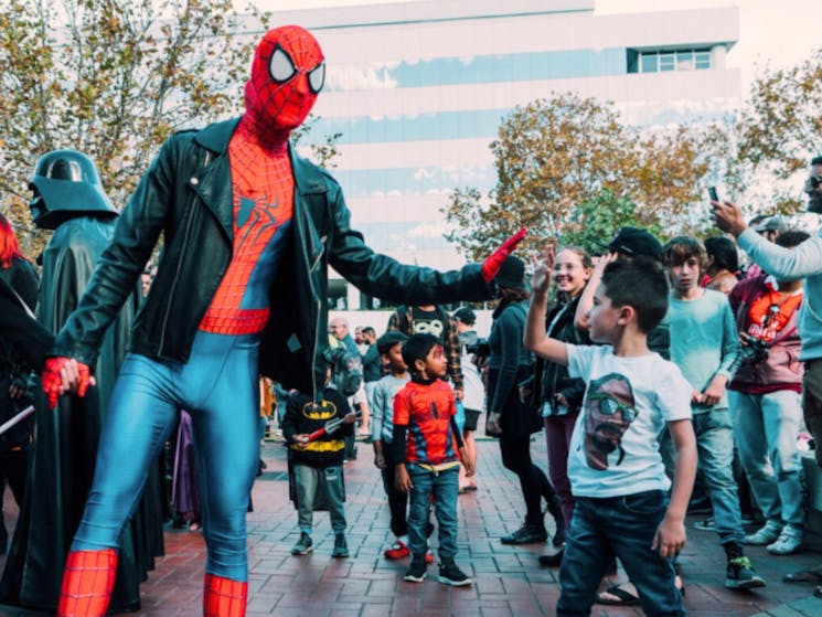 Spiderman and a young boy high fiving at Comic Gong