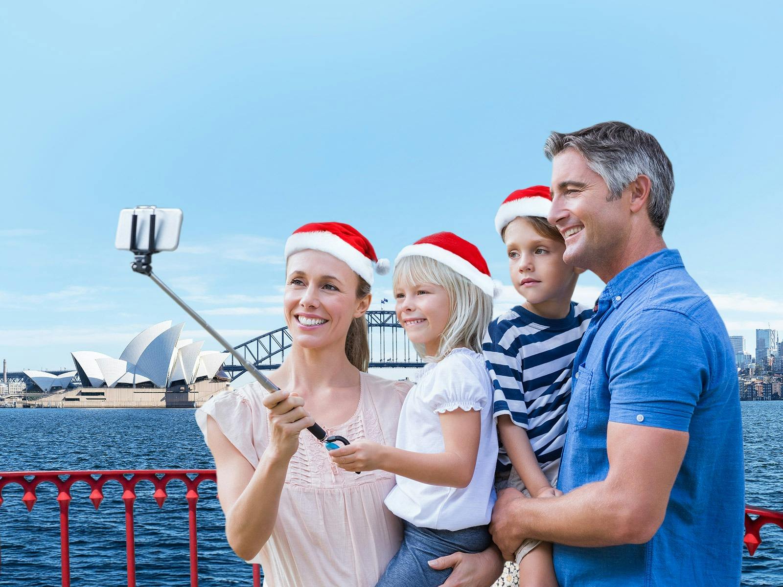 Family clicking a selfie on Showboat cruise with Opera house as backdrop