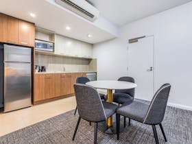 Fully equipped kitchen and dining area in apartments