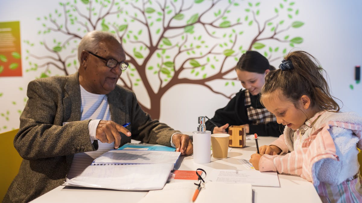 Man with two kids participating in museum activity