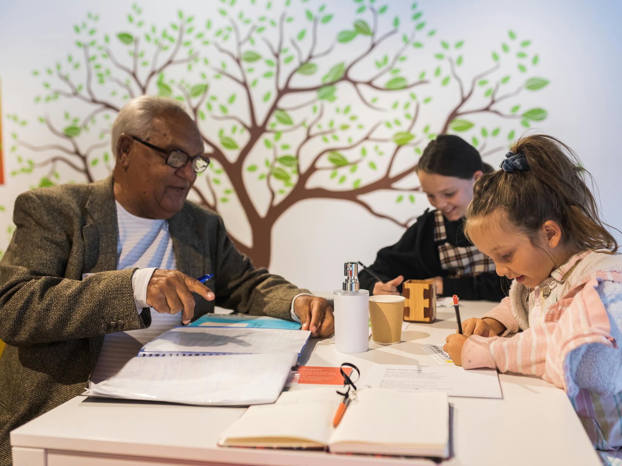 Man with two kids participating in museum activity