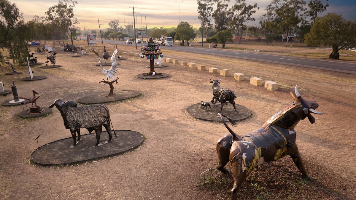 A range of metal sculptures sitting in an open park area