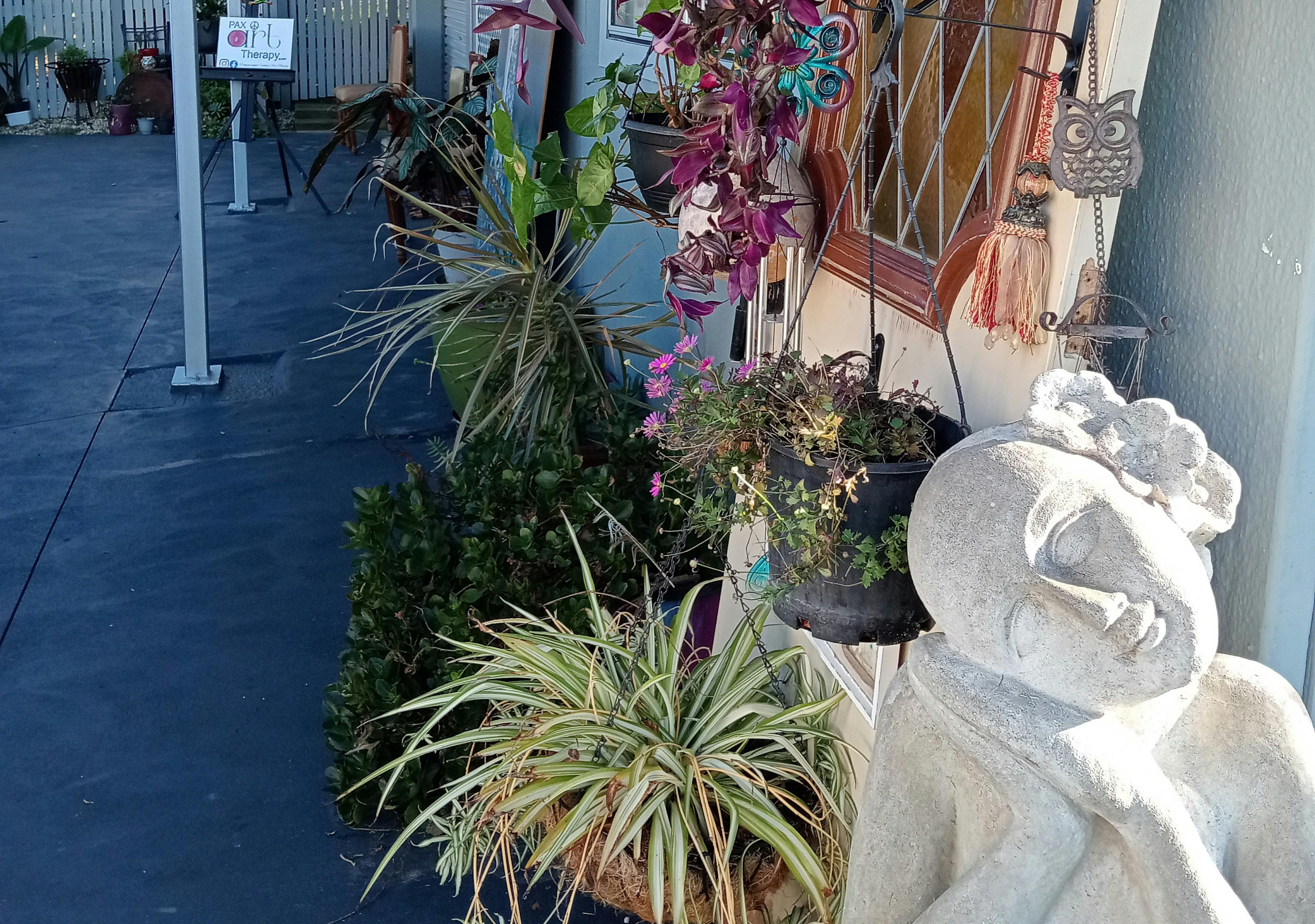 Pax Art Studio Gallery outside view plants art door sculpture