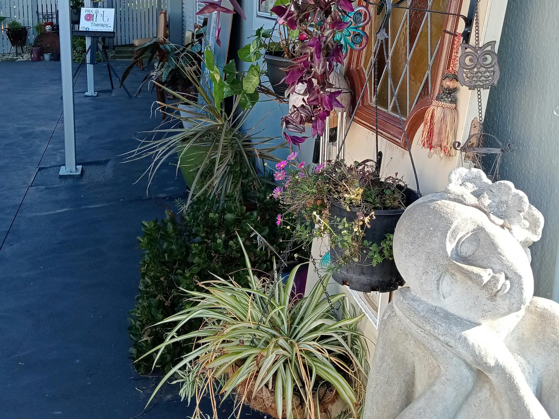 Pax Art Studio Gallery outside view plants art door sculpture