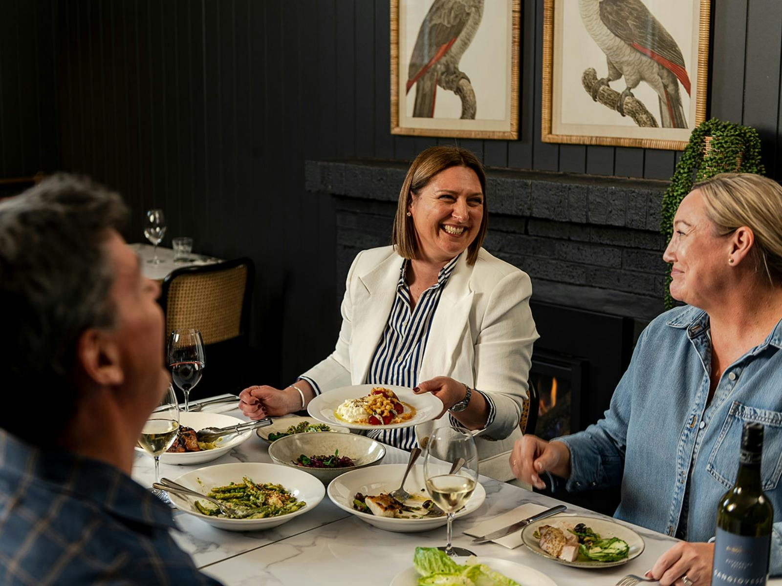 Guests enjoy a dinner in front of the fire at The Victoria Rutherglen