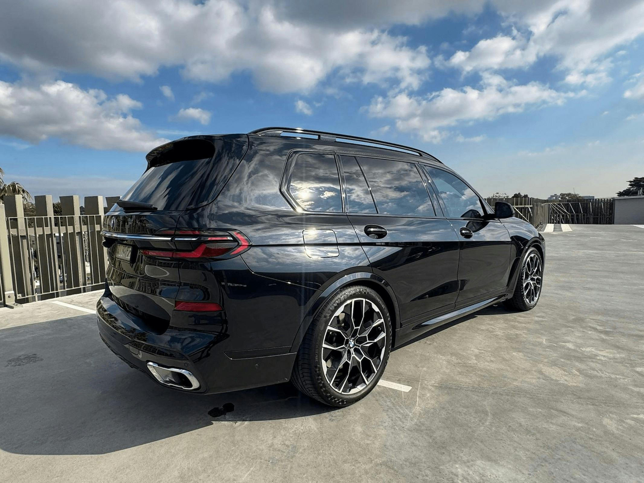 Black BMW X7 luxury chauffeur SUV from The First Chauffeurs parked in  Canberra
