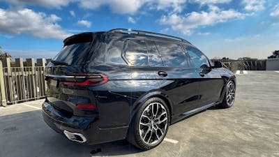 Black BMW X7 luxury chauffeur SUV from The First Chauffeurs parked in Canberra