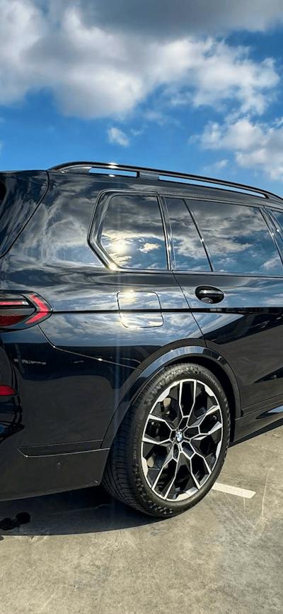 Black BMW X7 luxury chauffeur SUV from The First Chauffeurs parked in Canberra