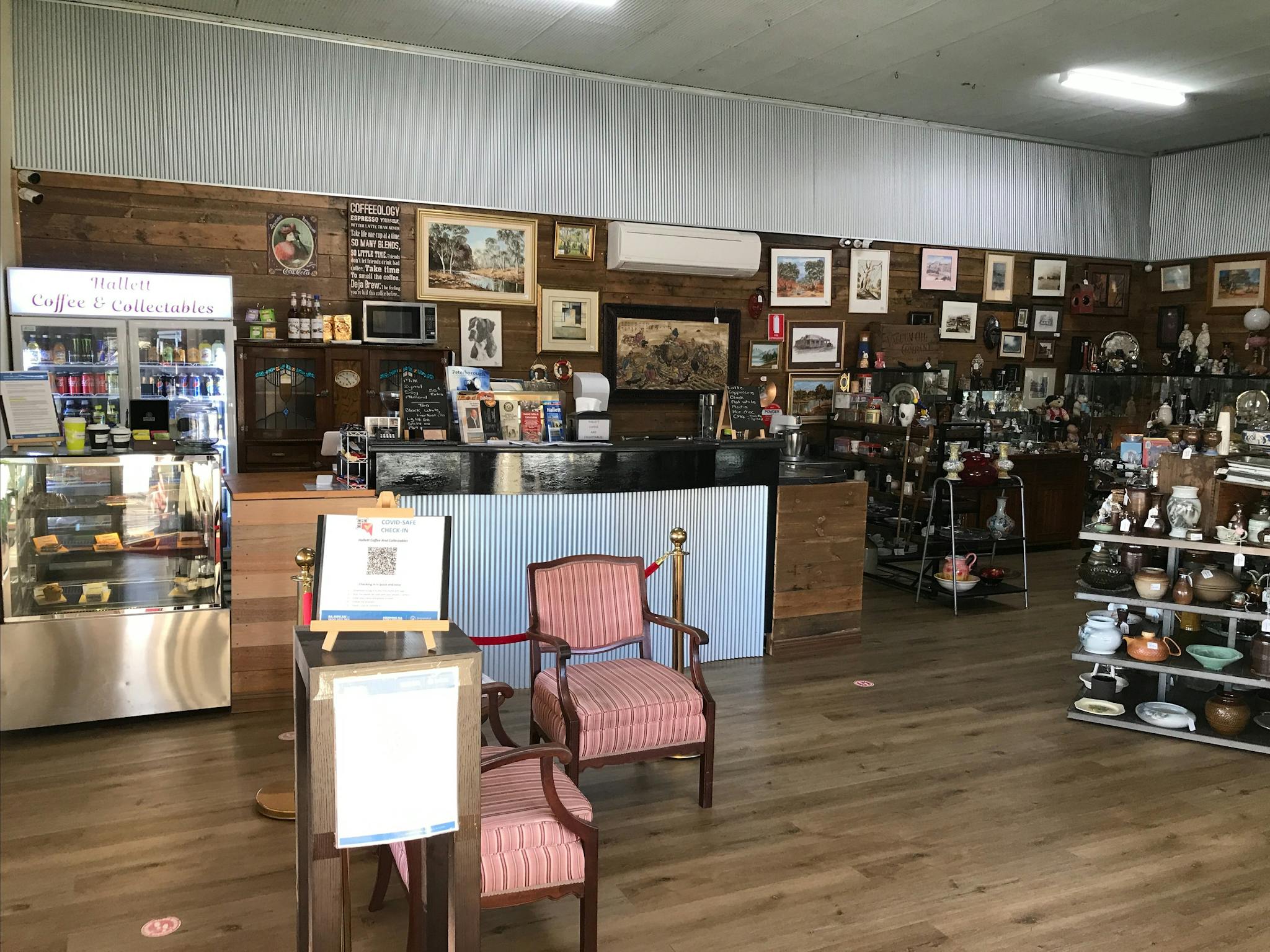 An interior view of Hallett Coffee & Collectables showing the café and cake fridge