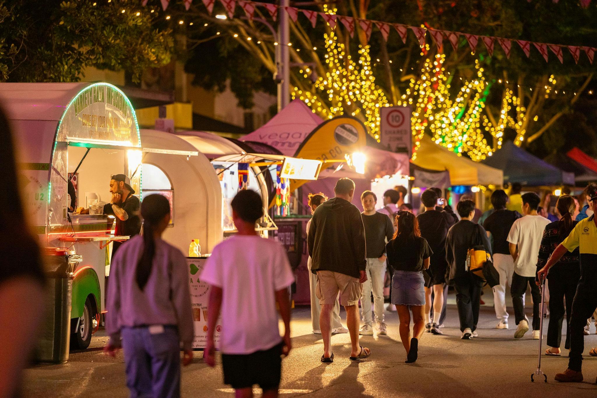 People walking through an evening market