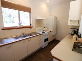 Fully equipped kitchen with ample kitchenware to enjoy a relaxing meal in your cottage