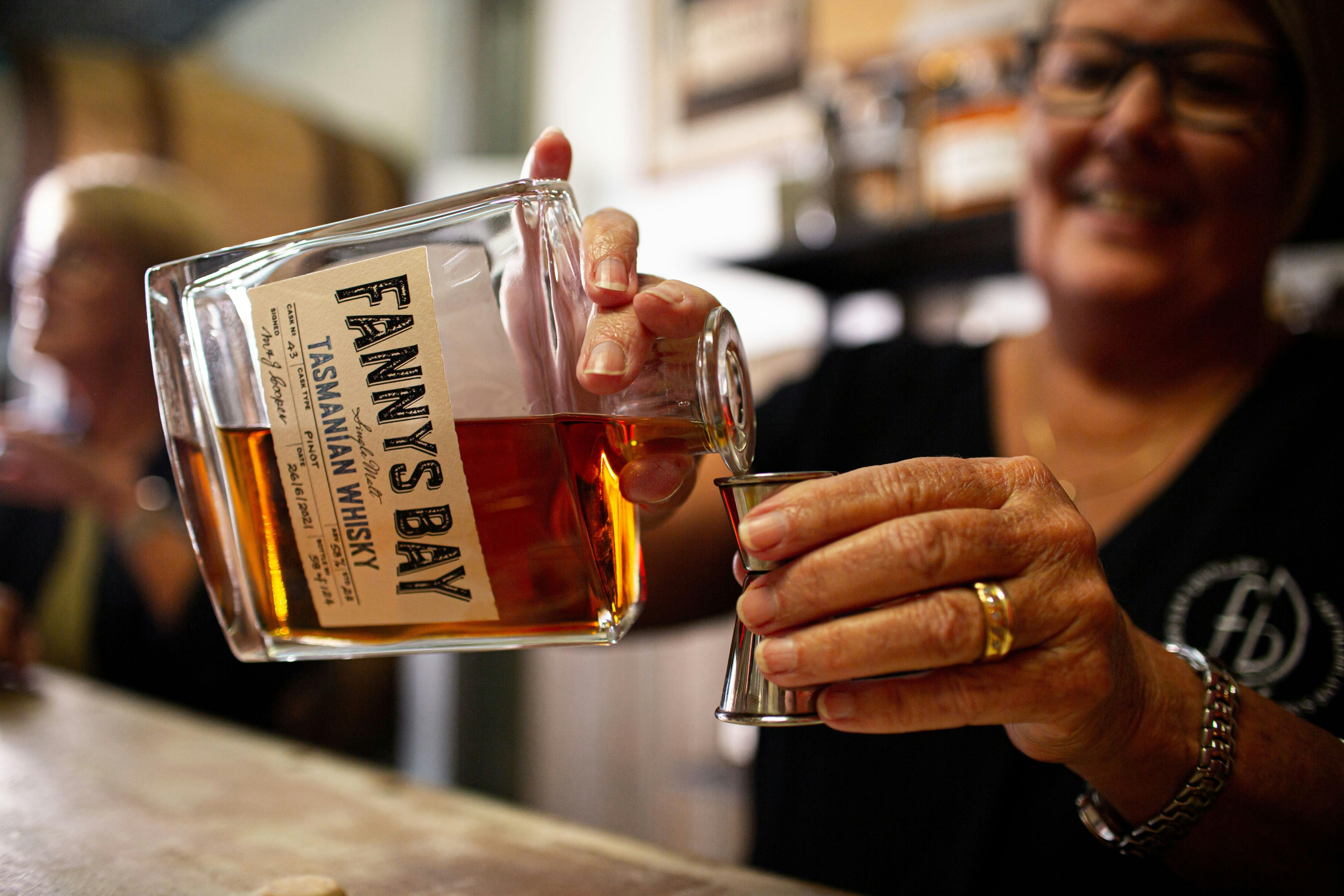Woman pouring whisky