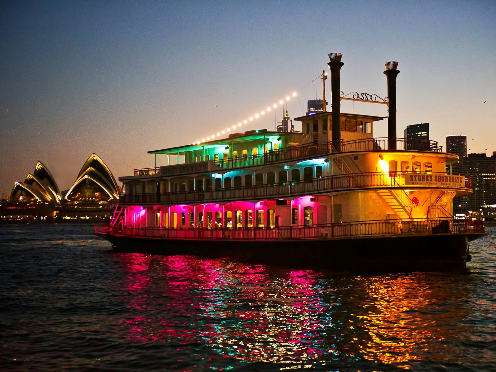 Vessel on harbour with Opera House in background.