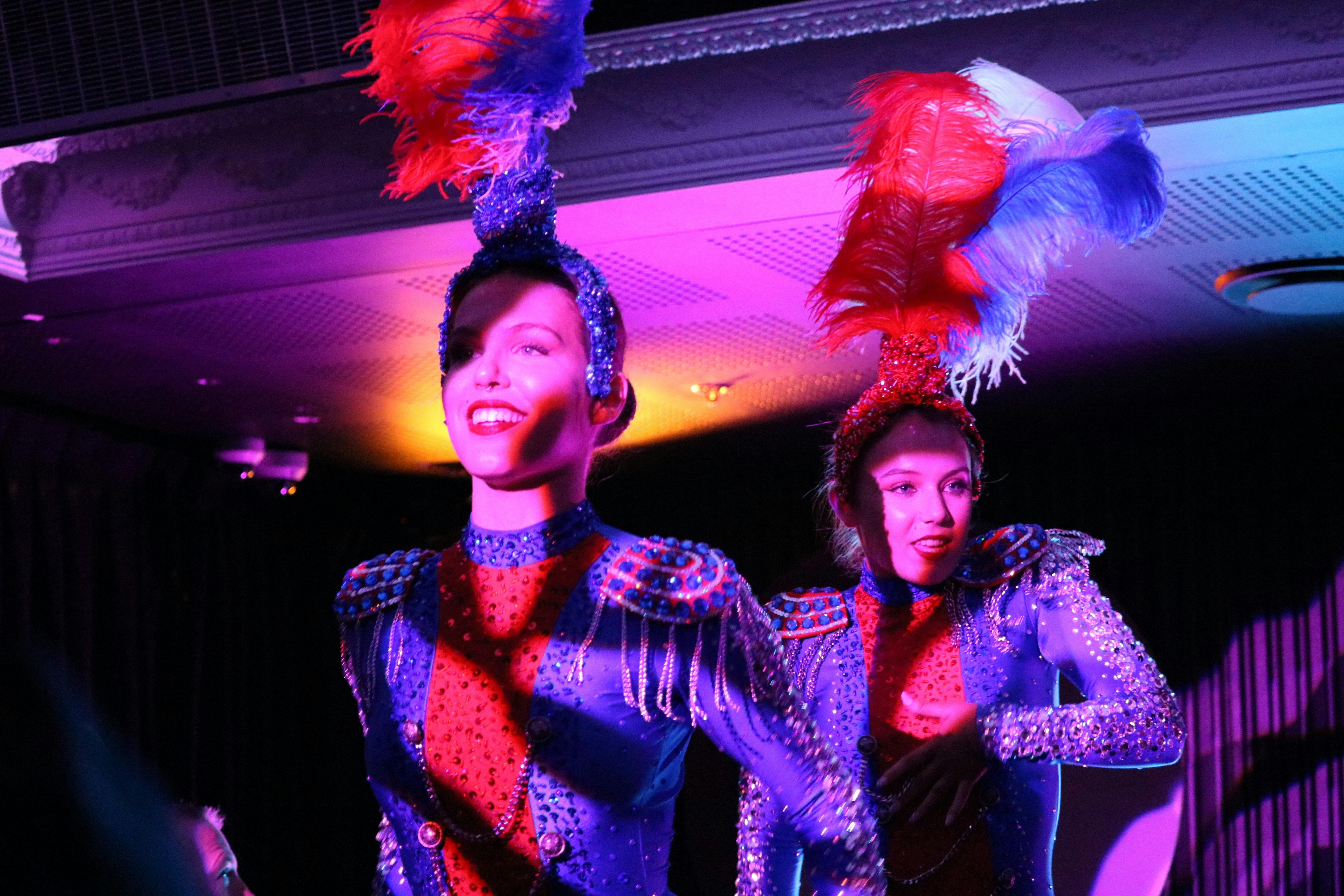 Two french showgirls dance on stage in a Christmas cabaret in Kings Cross