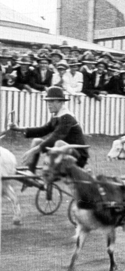 Black and white still from film of a horse race