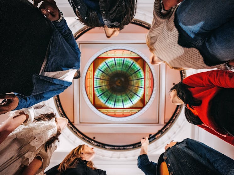 A tour group taking a photo from below up into the centre dome