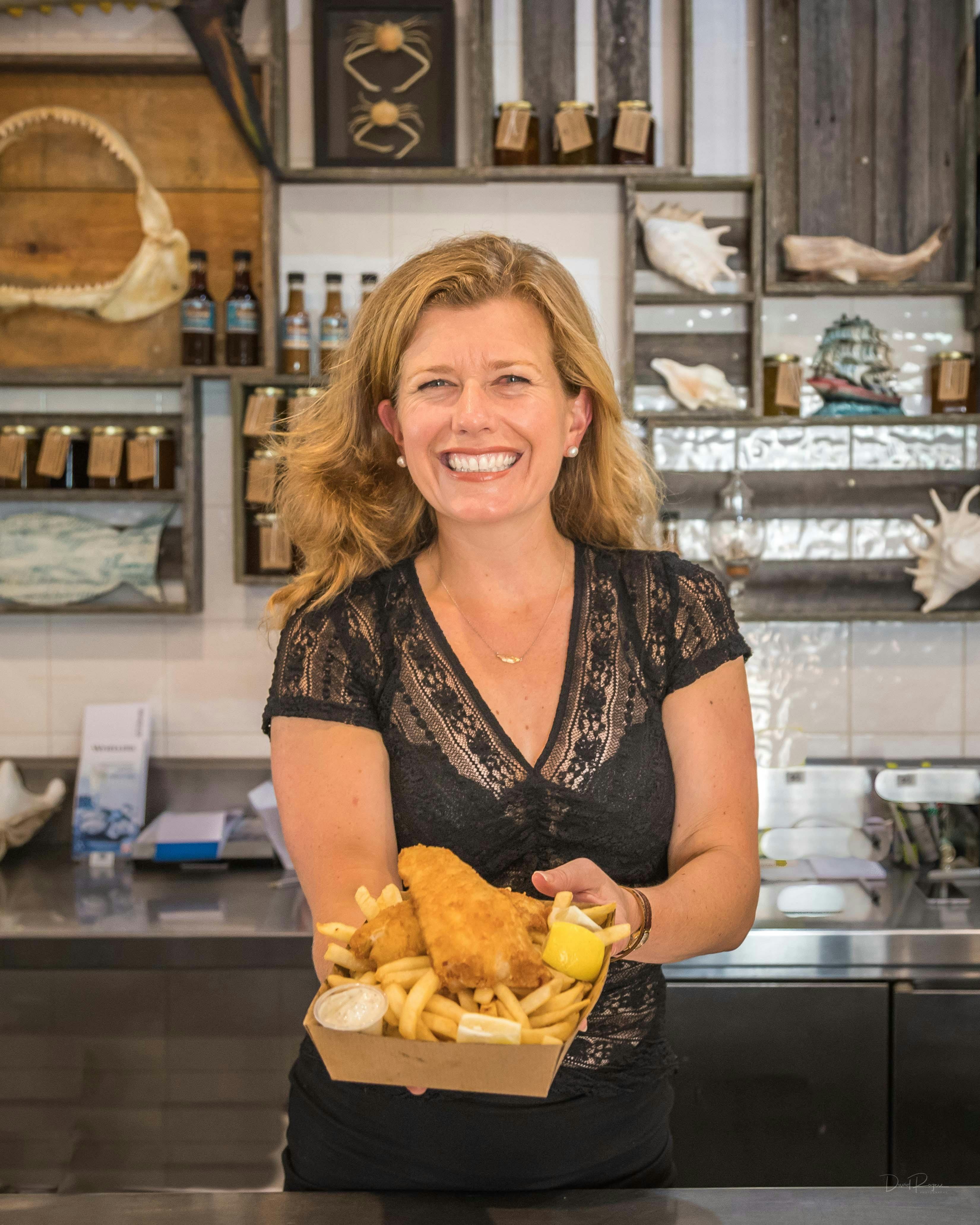 Jacqui serving fish and chips in the Takeaway Shop