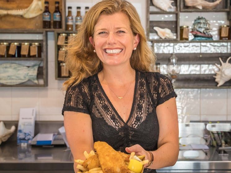 Jacqui serving fish and chips in the Takeaway Shop
