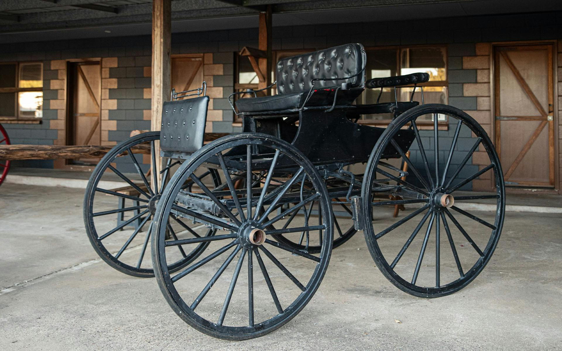 A classic cart displayed in front of the Stables rooms