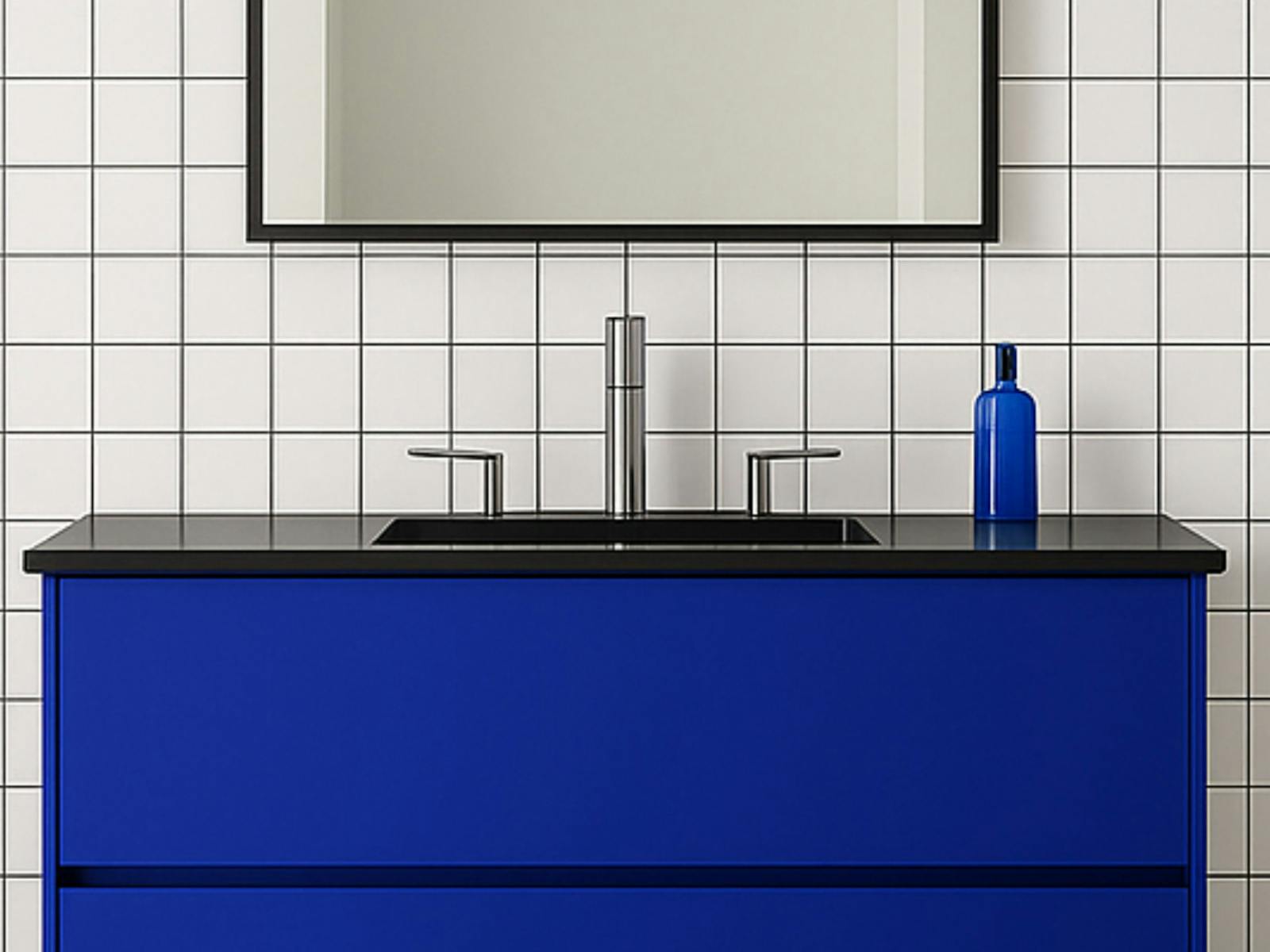 A blue vanity on a white tiled wall with mirror above
