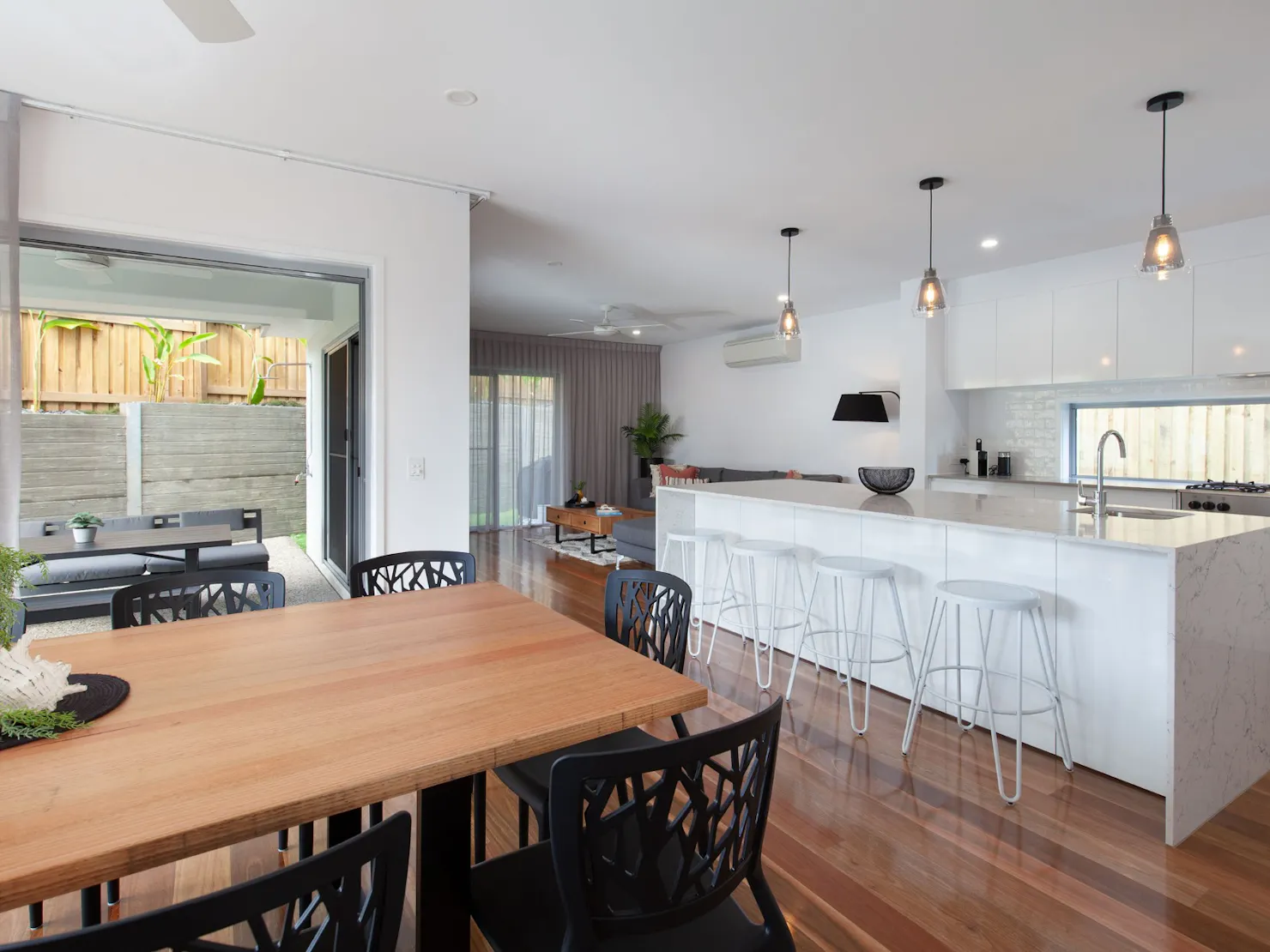 Open plan living kitchen and dining area with balcony access