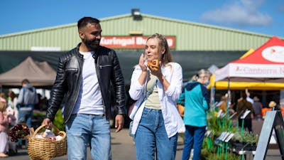 shoppers enjoying food and shopping at the farmers market