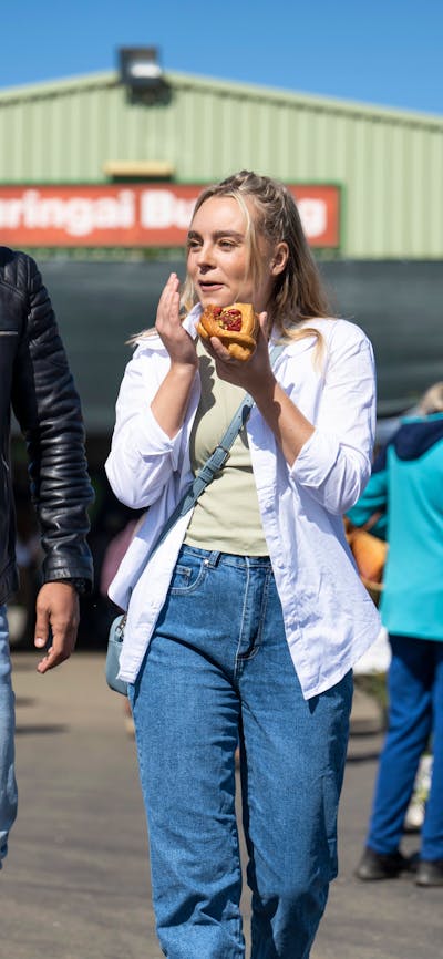 shoppers enjoying food and shopping at the farmers market