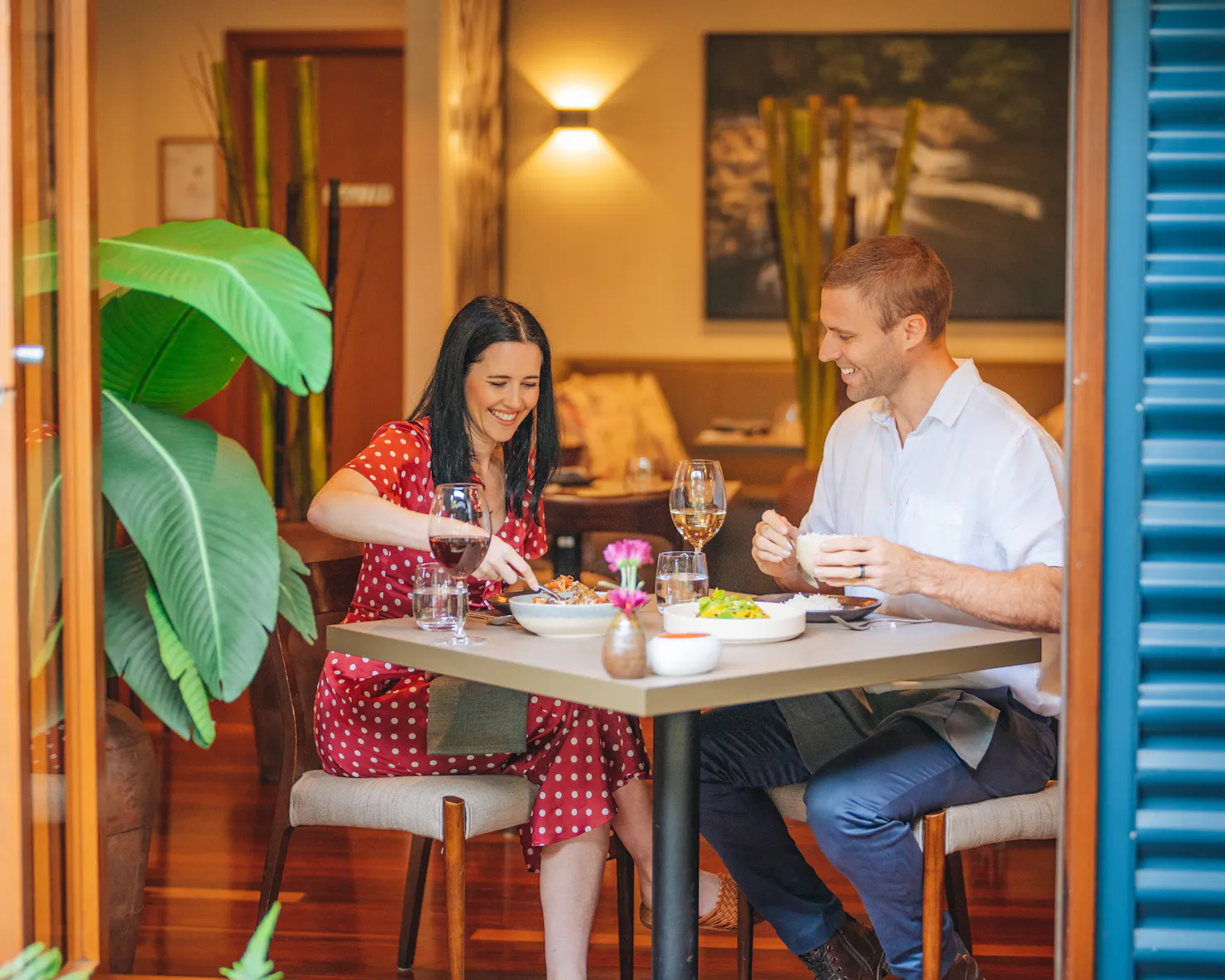 A couple smiling and eating together at The Tamarind