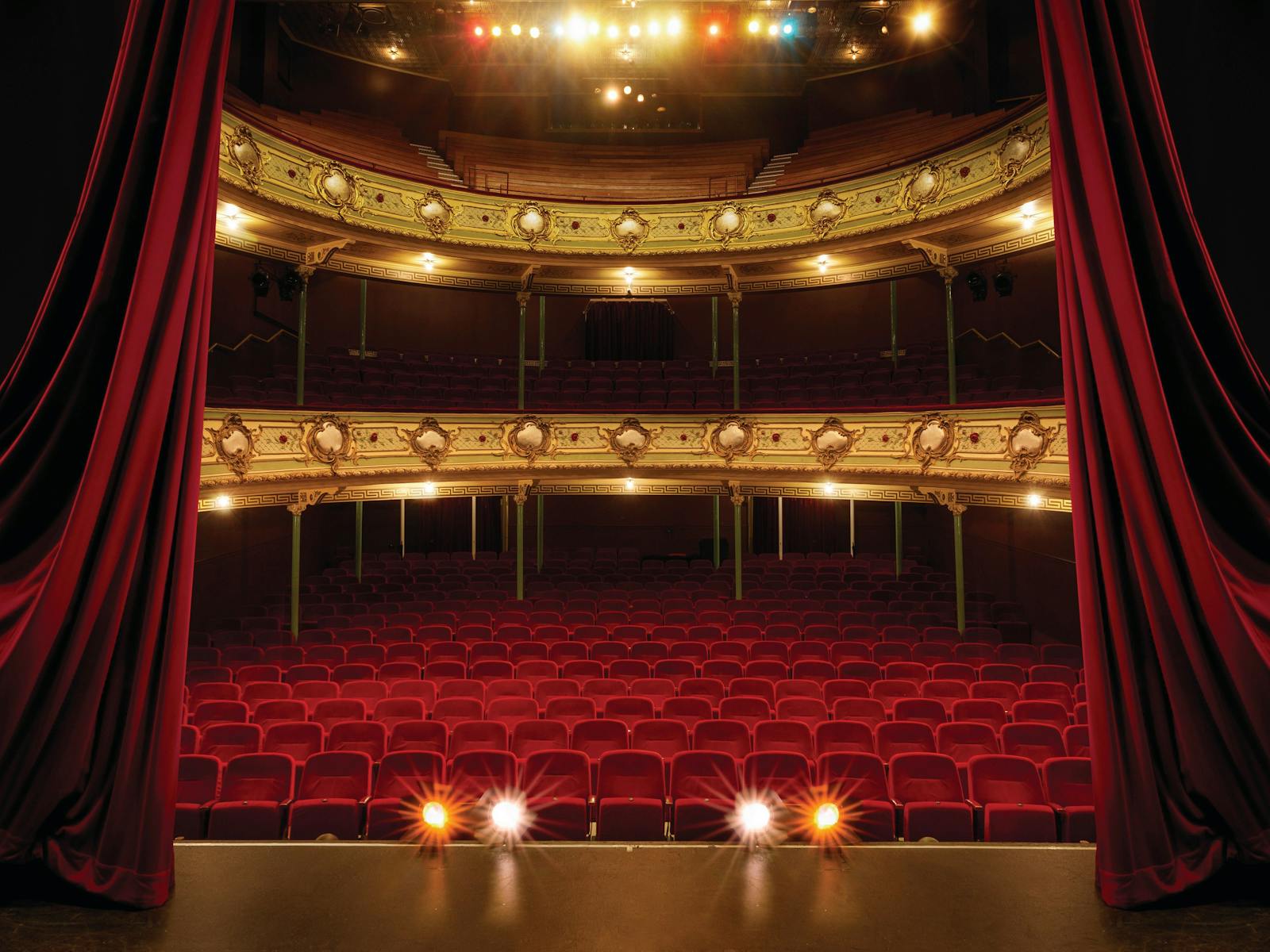 An ornate three-level theatre as viewed from the stage.
