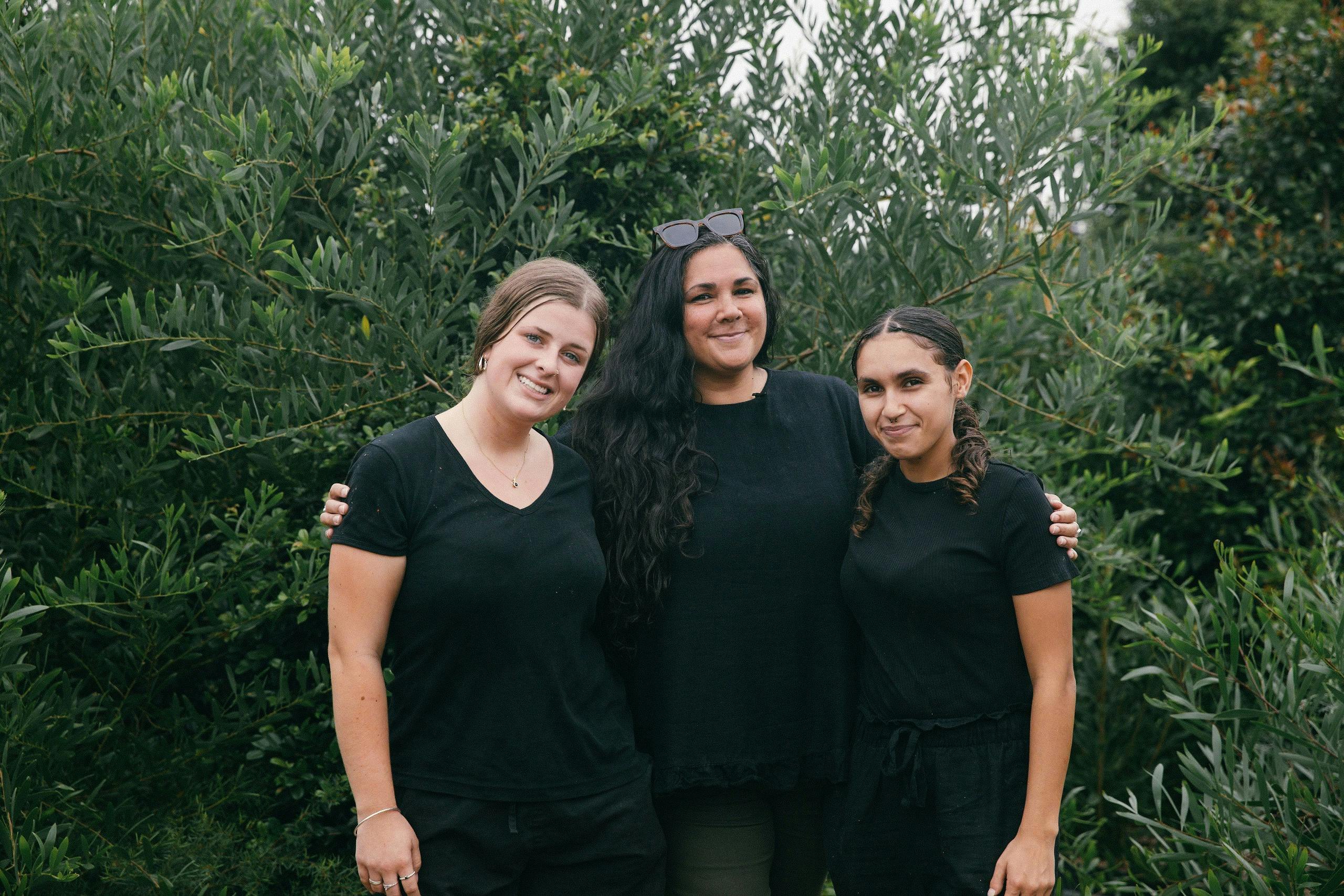 Three Blak Cede staff standing in Kareela Ngura community permaculture garden