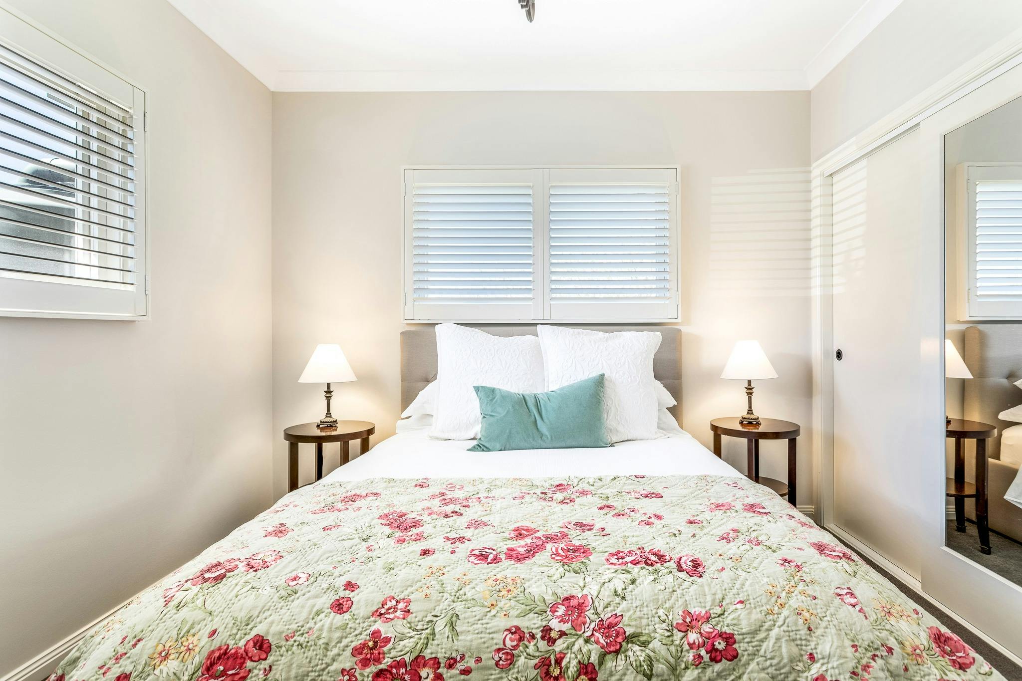 Shot of light and airy queen bedroom