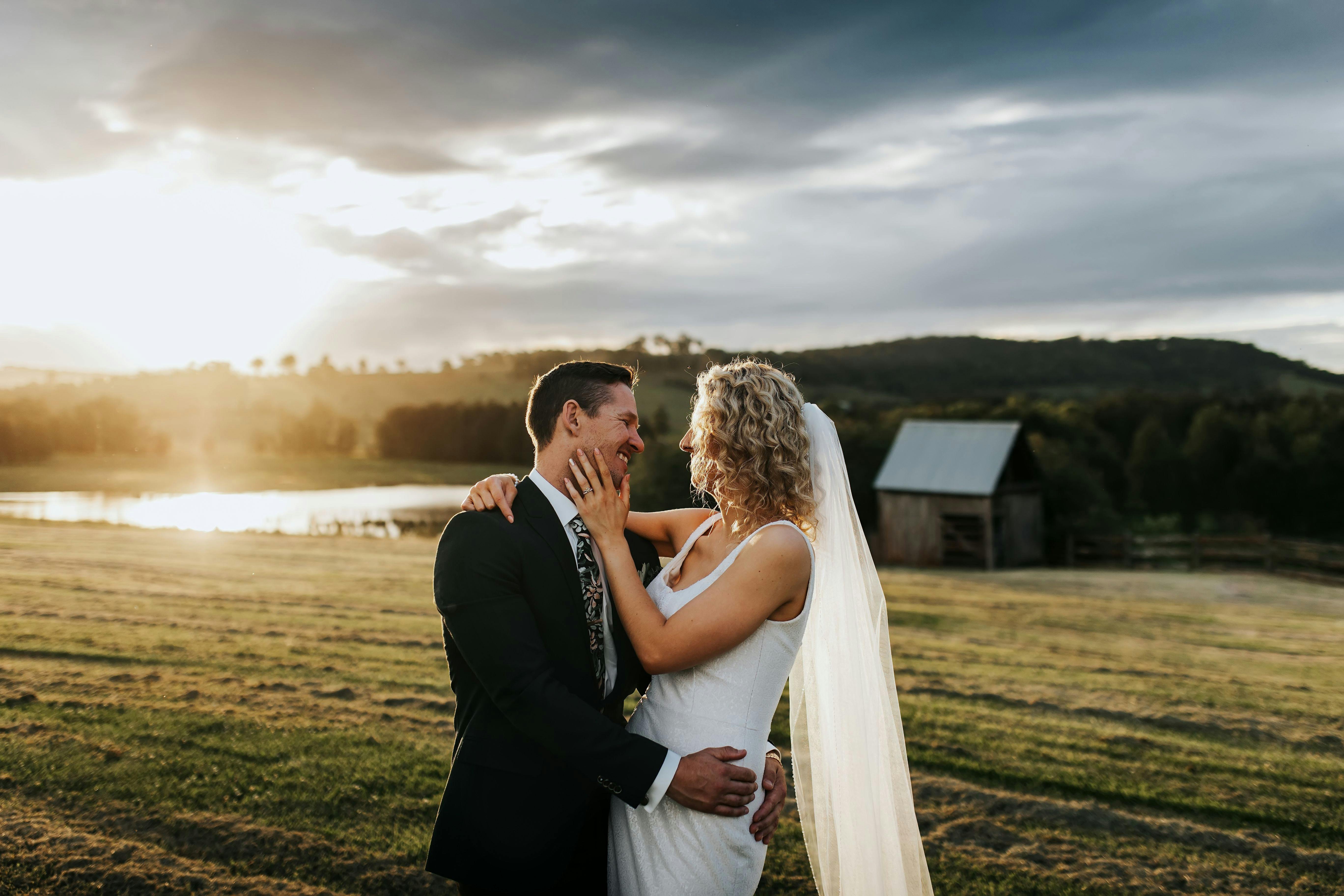Bride and groom in front of sunset