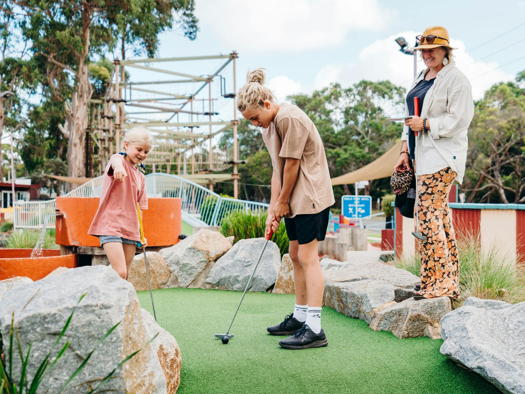 Family playing the 19 hole mini golf course at A Maze'N Things