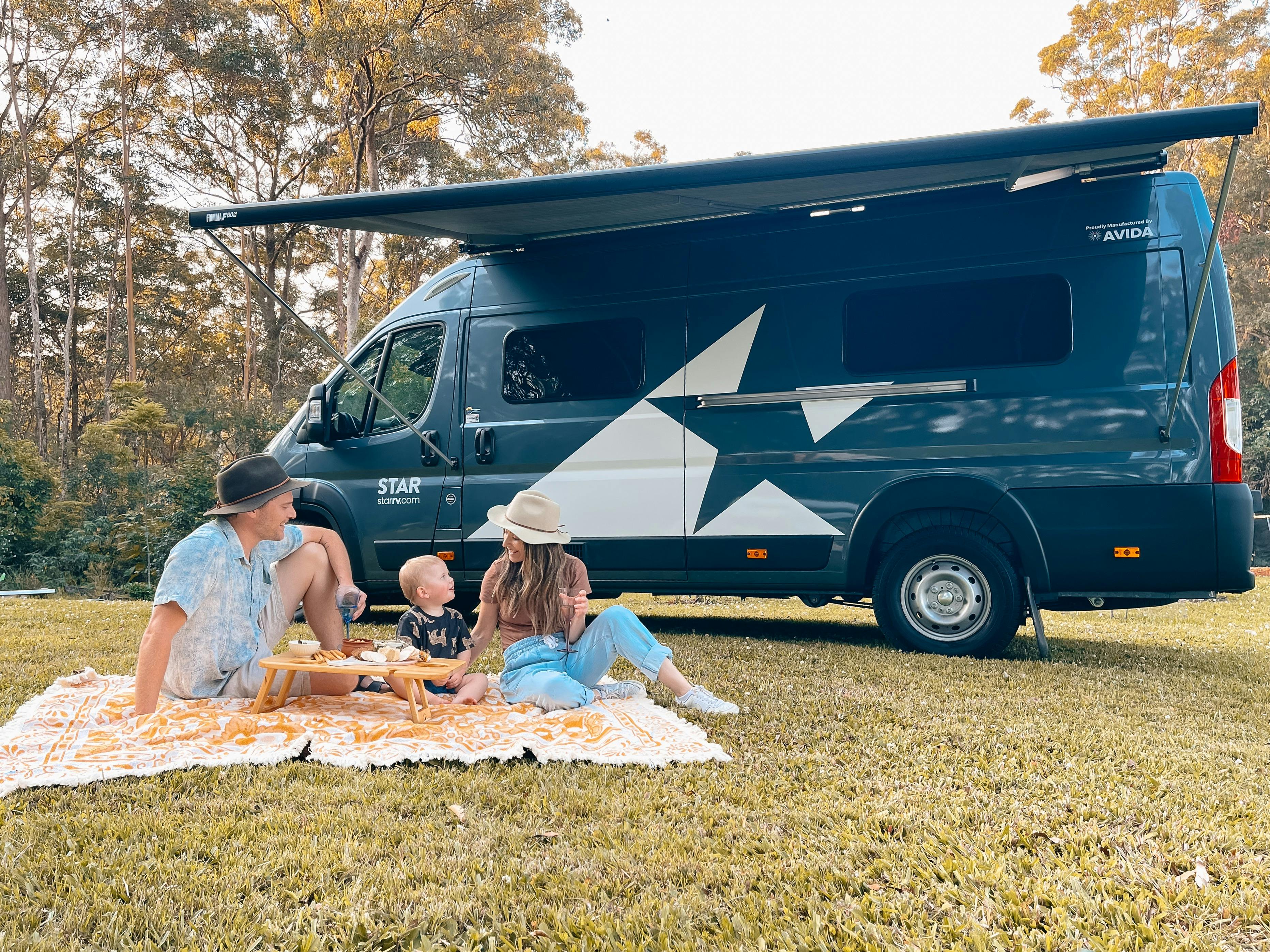 Family with a young child enjoying a picnic by Star RV Polaris 2 motorhome