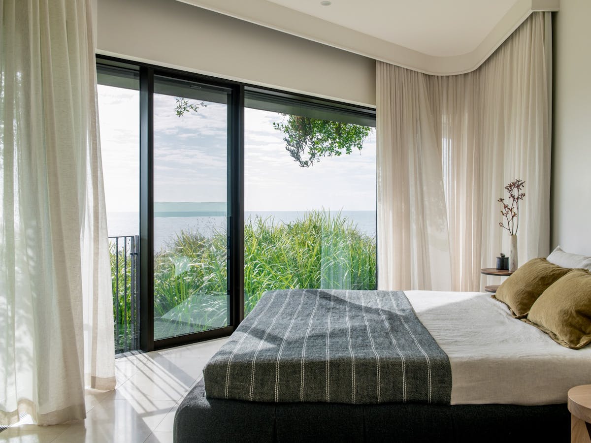Luxury bedroom with sweeping ocean views at Domic Noosa