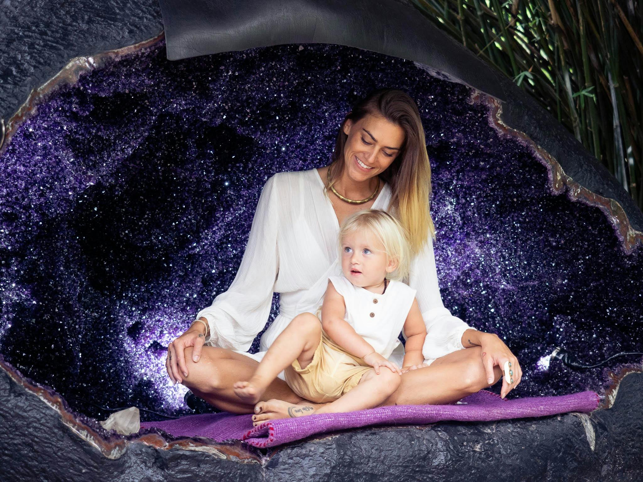 A mum and son sitting in the Dragon Egg amethyst geode