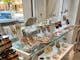 white and glass shelving displaying jewellery, ceramics and produce