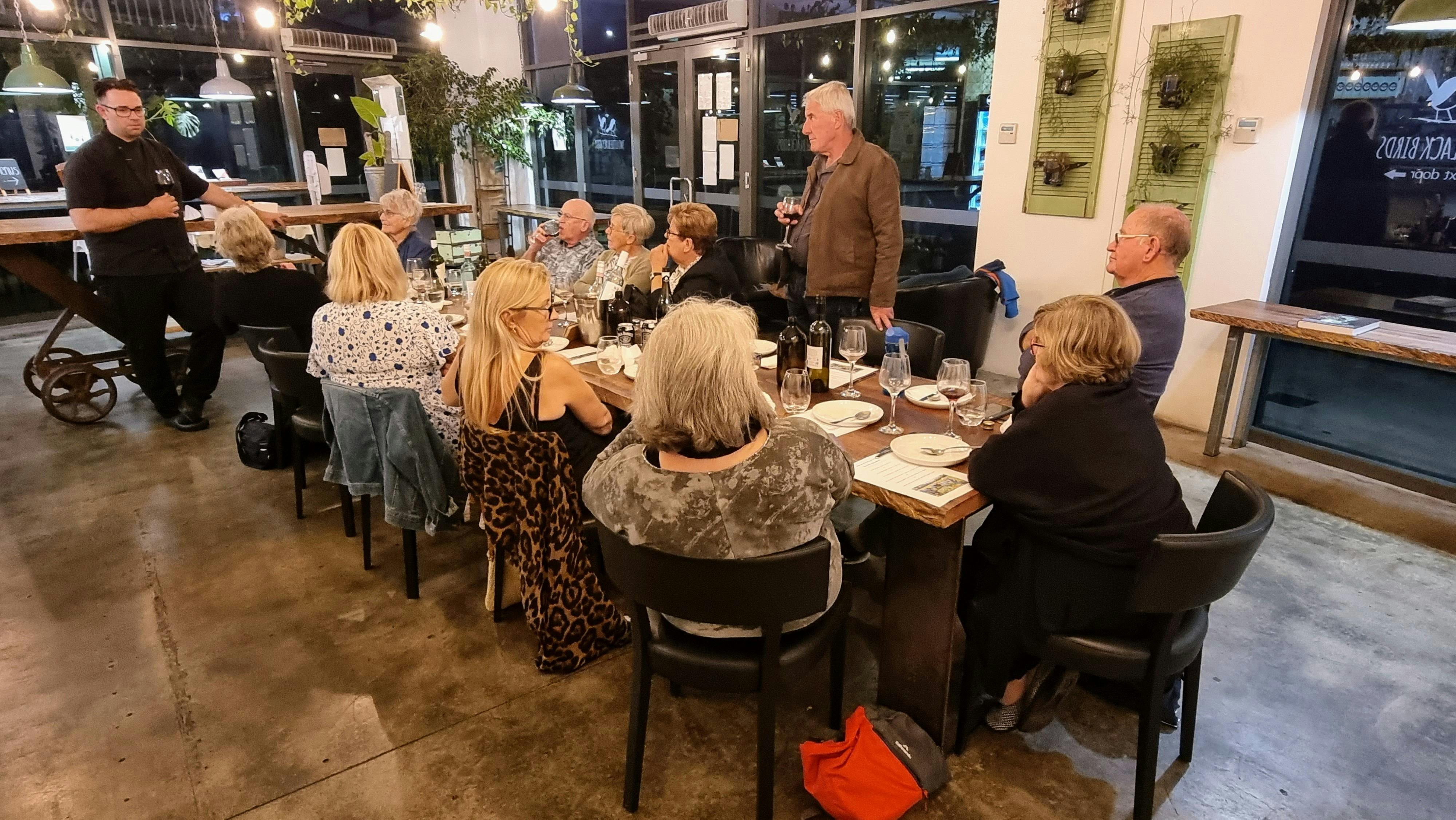 group of people sitting around a table at dinner
