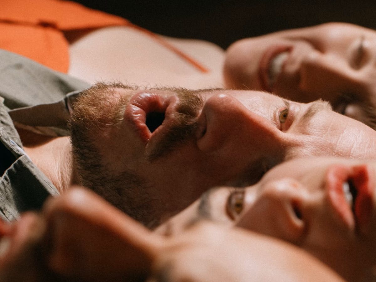 Five singers lying down arranged with interlocking heads
